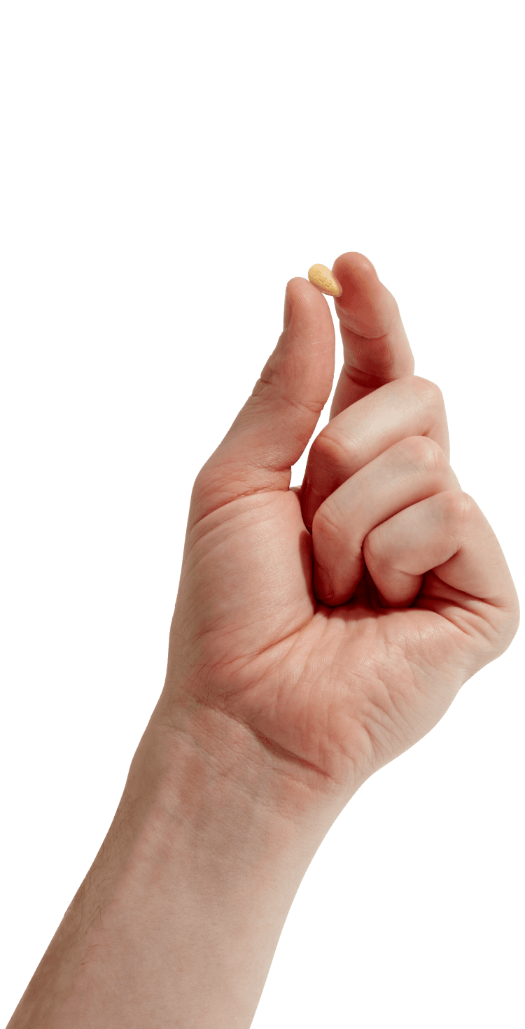 Hand holding a tadalafil pill