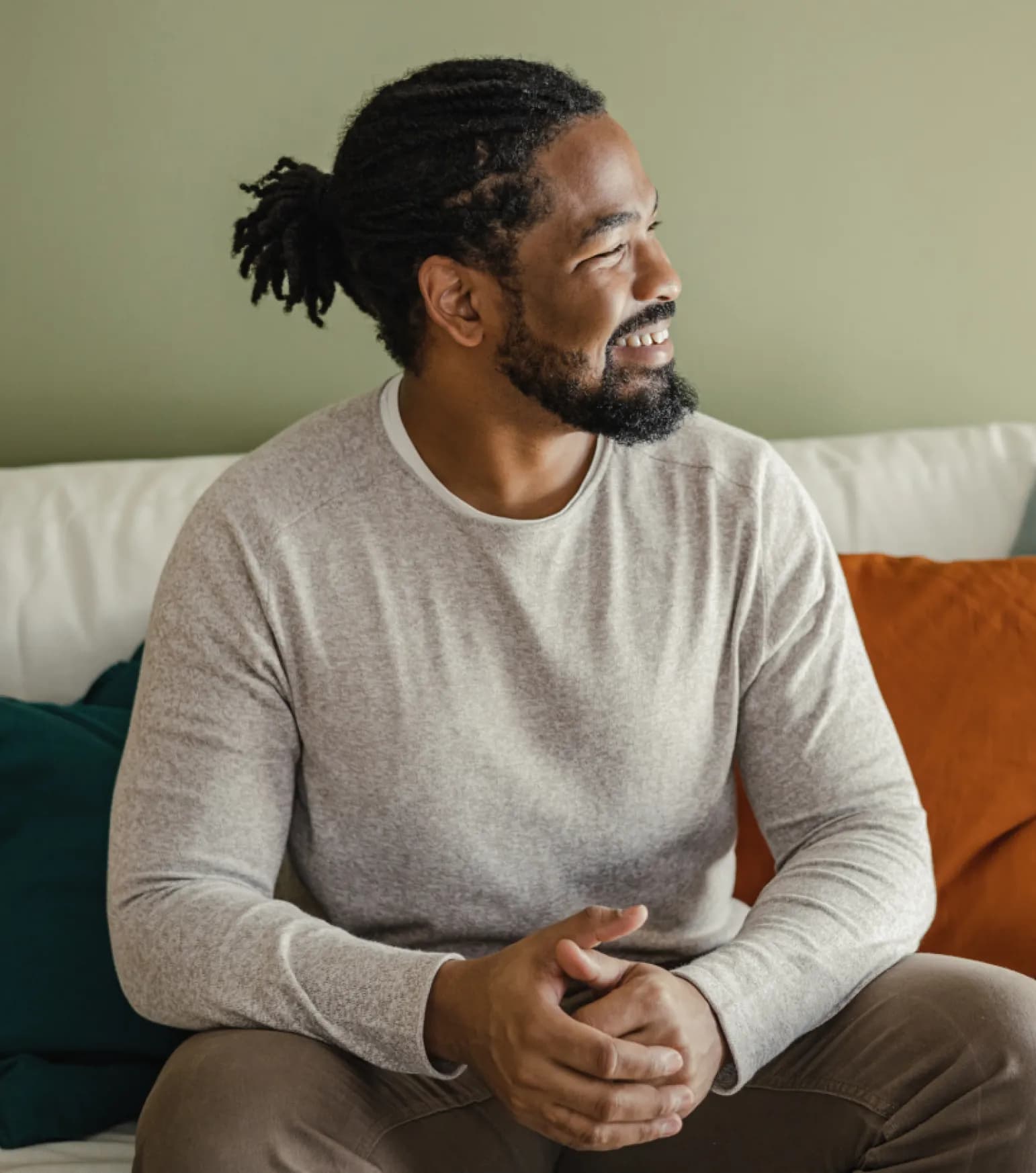 smiling man sitting on sofa