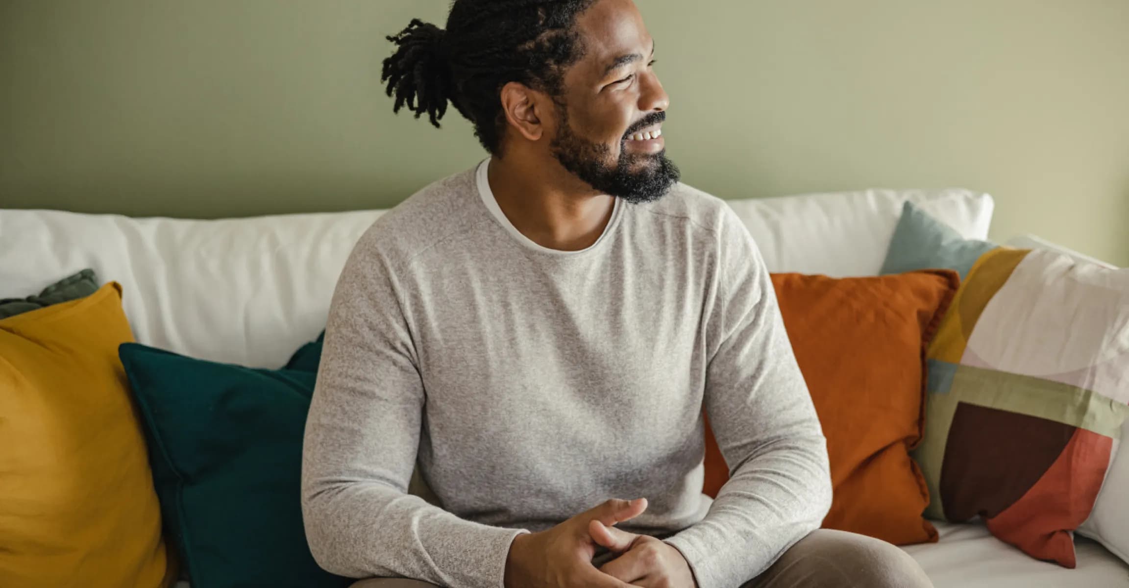 smiling man sitting on sofa